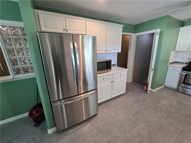 kitchen featuring white cabinets and appliances with stainless steel finishes