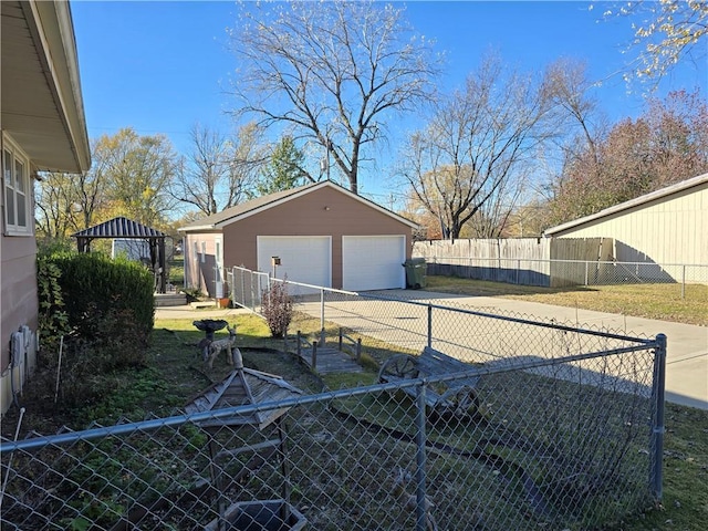 view of yard featuring a gazebo, a garage, and an outdoor structure