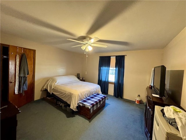 bedroom featuring ceiling fan and dark carpet