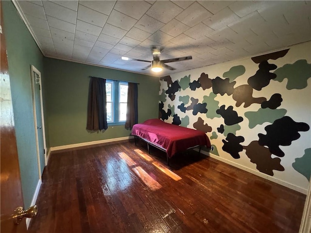 unfurnished bedroom with ceiling fan and dark wood-type flooring