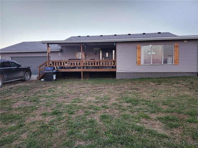 rear view of property featuring a yard