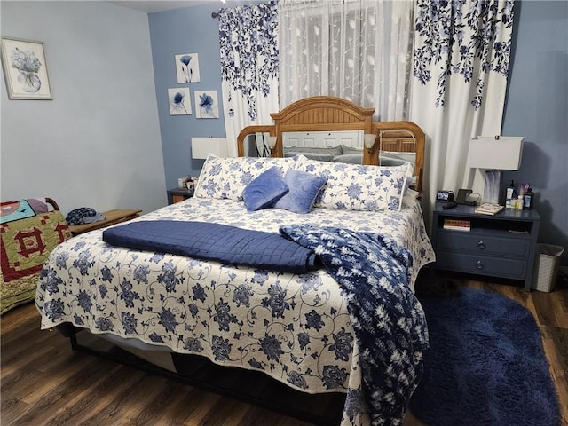 bedroom with dark wood-type flooring