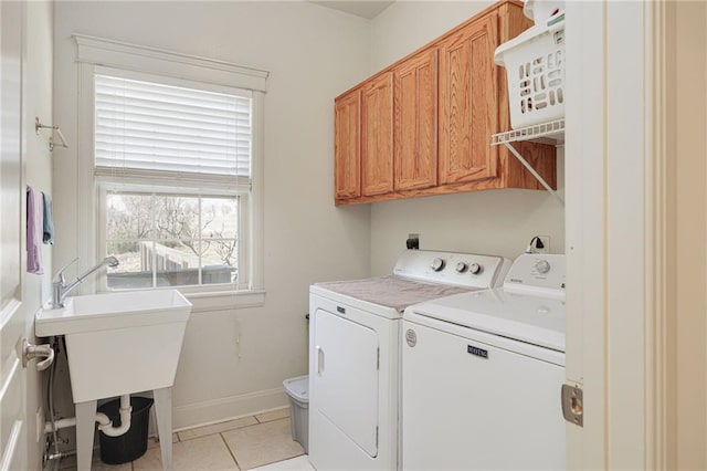 laundry room with light tile patterned flooring, cabinets, and separate washer and dryer