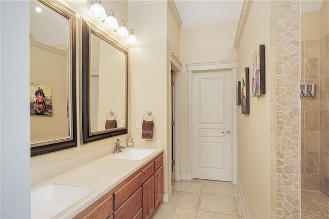 bathroom with tile patterned flooring, vanity, tiled shower, and crown molding