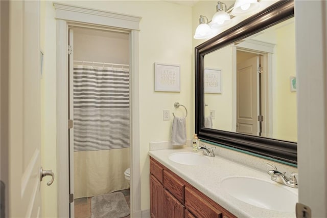 bathroom with vanity, toilet, and walk in shower