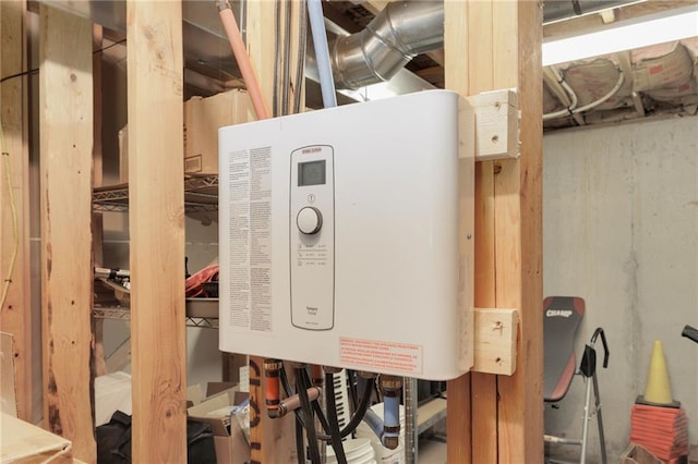 utility room featuring tankless water heater