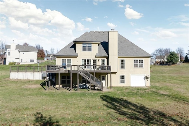 rear view of house with a lawn, a deck, and a garage