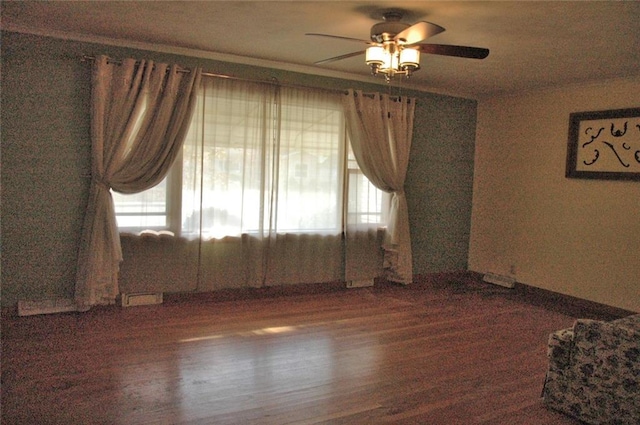 empty room with ceiling fan and dark wood-type flooring