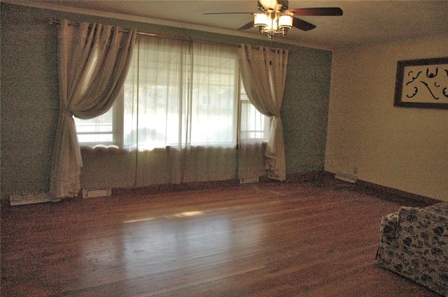 spare room with ceiling fan and dark hardwood / wood-style floors