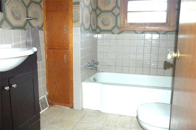 bathroom featuring tasteful backsplash, tile patterned flooring, vanity, and toilet