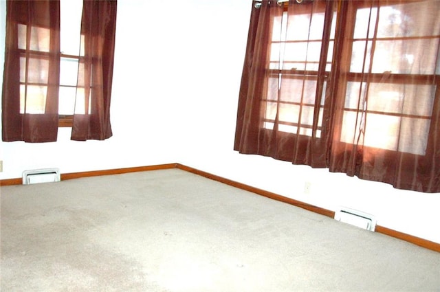 spare room with carpet flooring and plenty of natural light