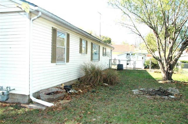 view of property exterior with a yard and central AC unit