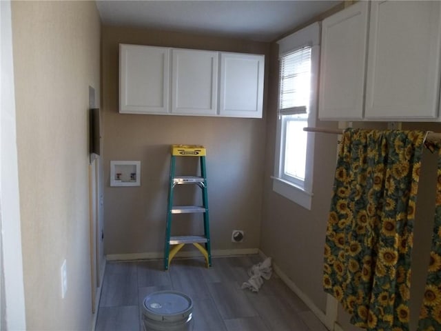 laundry area featuring hookup for a washing machine, cabinets, and light hardwood / wood-style flooring