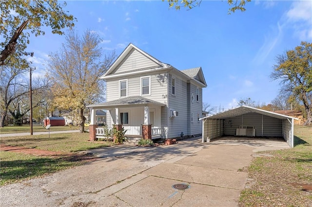 view of front property with a carport, covered porch, and a front lawn