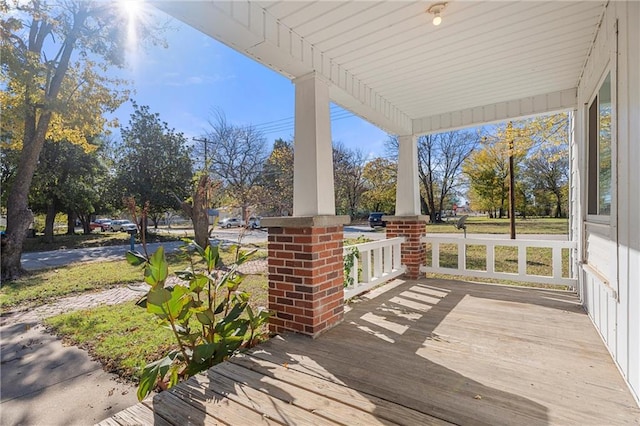 wooden terrace featuring covered porch