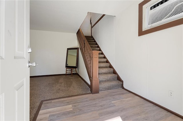 stairway featuring wood-type flooring