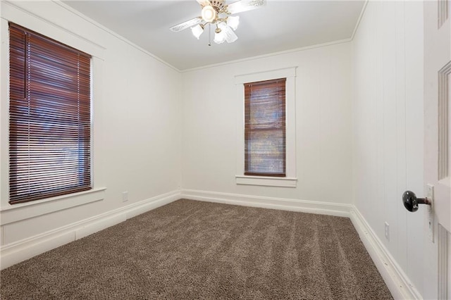 empty room featuring carpet, ceiling fan, and crown molding