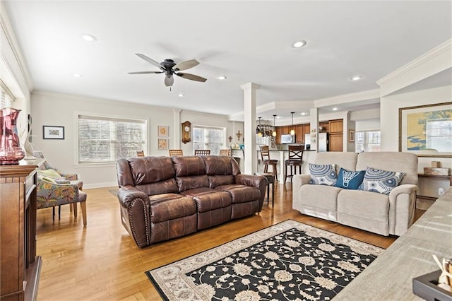 living room with ceiling fan, crown molding, and light hardwood / wood-style floors