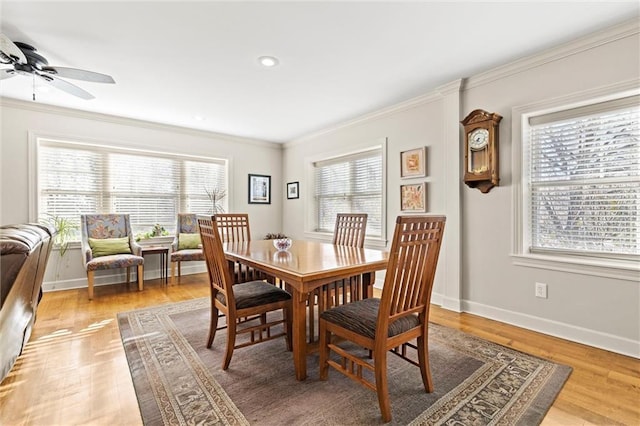 dining space with hardwood / wood-style flooring, crown molding, a wealth of natural light, and ceiling fan