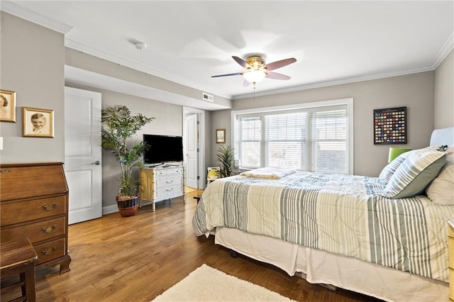 bedroom featuring crown molding, ceiling fan, and hardwood / wood-style floors