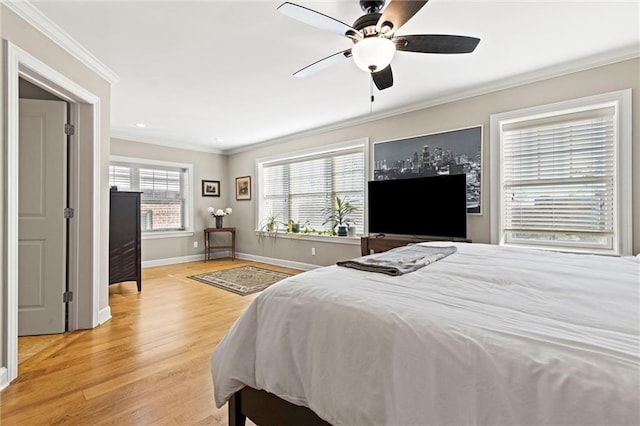 bedroom featuring crown molding, ceiling fan, and light hardwood / wood-style floors