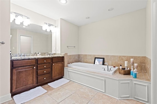 bathroom with vanity, a bathtub, and tile patterned flooring