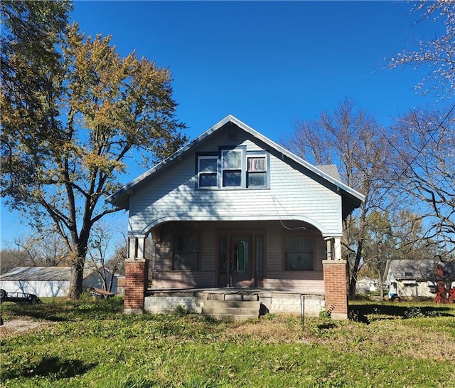 view of front of home with a front lawn and covered porch