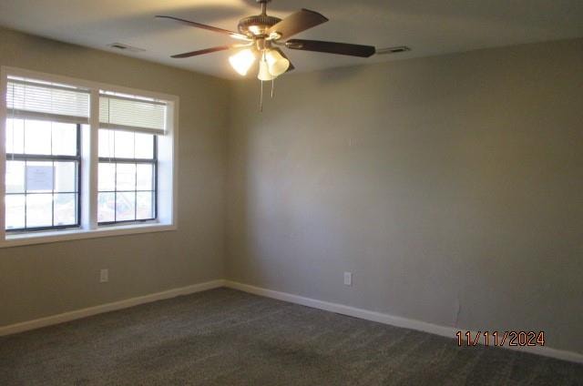 carpeted empty room featuring ceiling fan