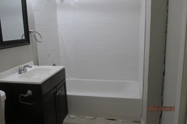 full bathroom featuring vanity, toilet, and tiled shower / bath