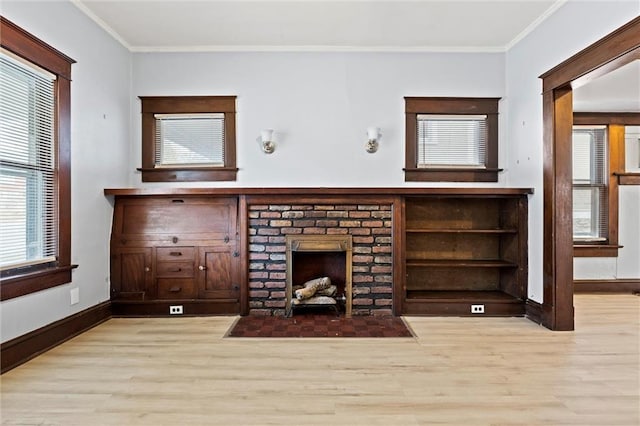 unfurnished living room with a fireplace, light wood-type flooring, and crown molding