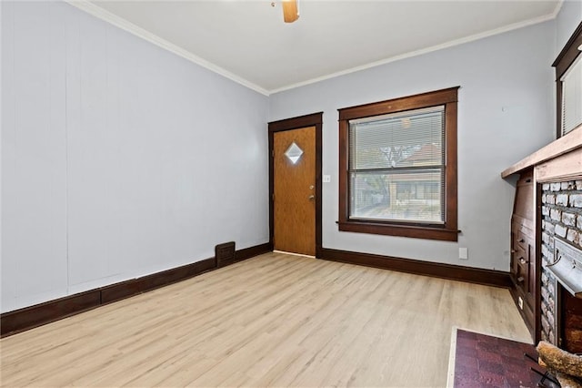 foyer entrance featuring ornamental molding and light hardwood / wood-style flooring