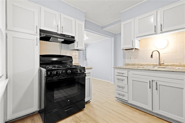 kitchen with white cabinets, black gas range oven, and light hardwood / wood-style flooring