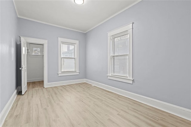 unfurnished room featuring crown molding and light wood-type flooring