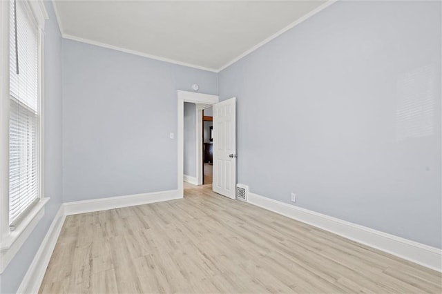 unfurnished room featuring light hardwood / wood-style flooring and ornamental molding