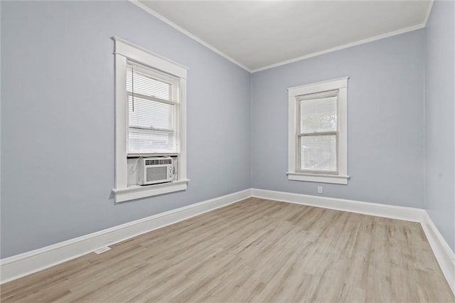 empty room featuring light hardwood / wood-style flooring, cooling unit, and ornamental molding