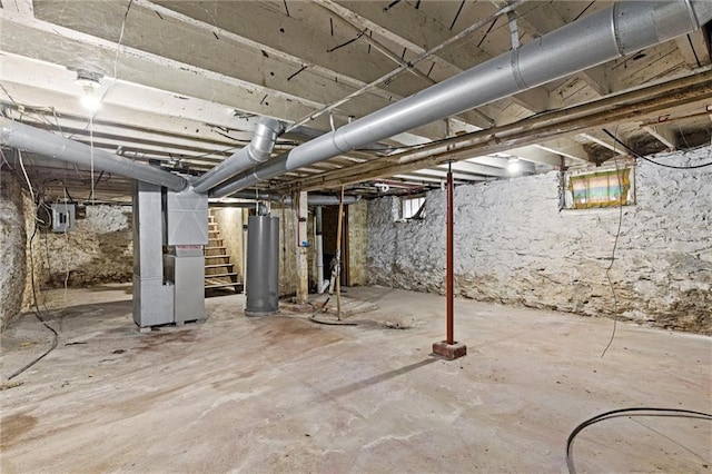 basement with water heater, electric panel, and heating unit