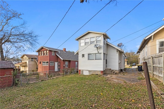 back of house with a lawn