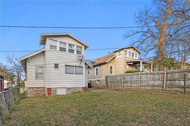 back of property featuring a lawn