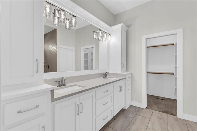 4520 NW 49th Ct, Riverside, MO 64150 - full bath with double vanity, baseboards, and a walk in closet