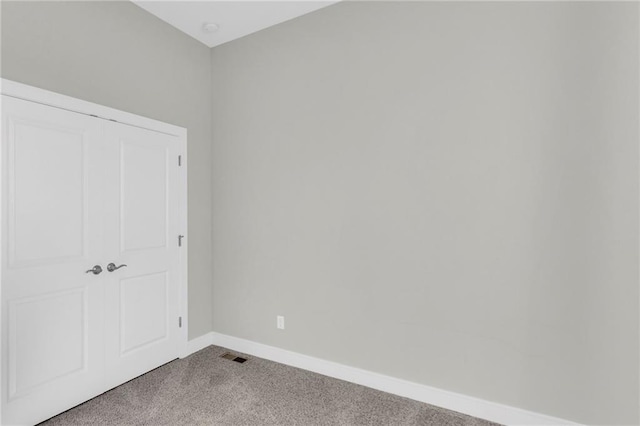 unfurnished bedroom featuring carpet and a closet