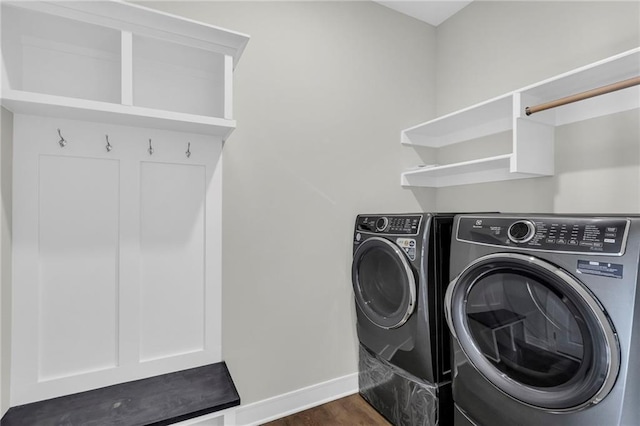 washroom featuring dark wood-type flooring and washing machine and clothes dryer