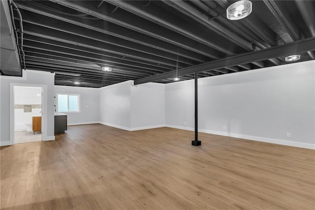 basement with hardwood / wood-style flooring