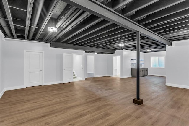 basement featuring hardwood / wood-style floors