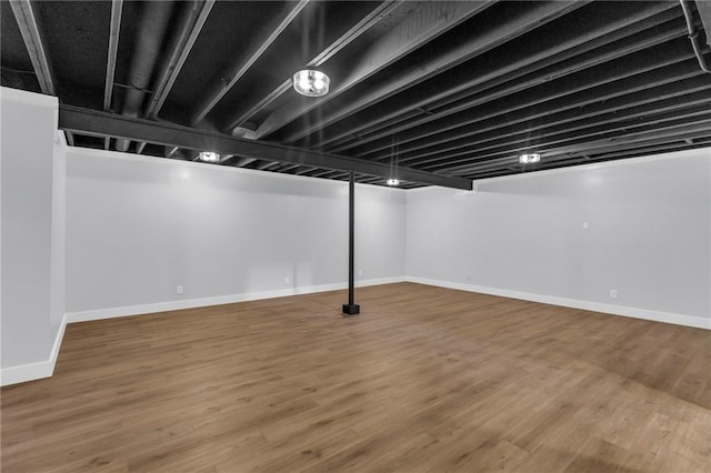 basement with hardwood / wood-style floors