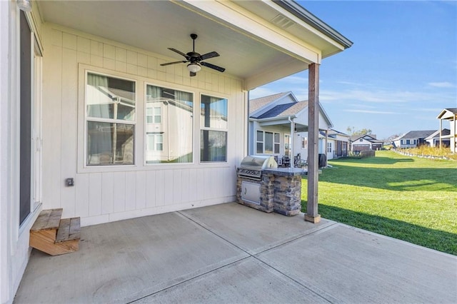 view of patio featuring area for grilling, ceiling fan, and exterior kitchen