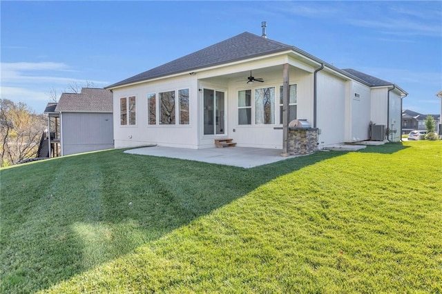 back of house with ceiling fan, a yard, cooling unit, and a patio