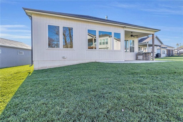 exterior space featuring a front lawn and ceiling fan