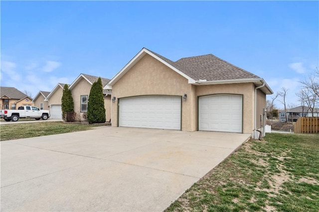 view of front of house with stucco siding, a front lawn, concrete driveway, a shingled roof, and a garage