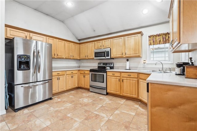 kitchen with light countertops, lofted ceiling, recessed lighting, stainless steel appliances, and a sink