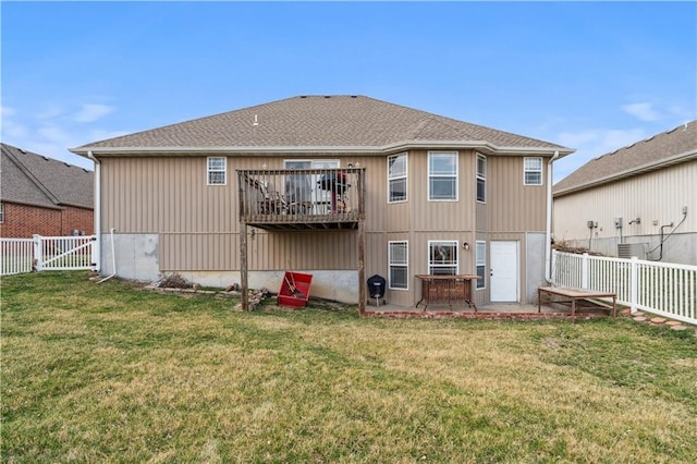 back of house featuring a lawn and a fenced backyard